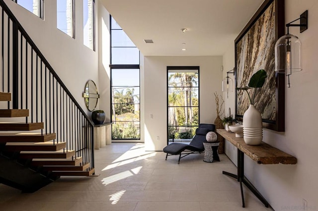 foyer entrance featuring a towering ceiling