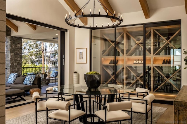 wine cellar with a notable chandelier, vaulted ceiling with beams, and hardwood / wood-style flooring