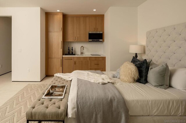 bedroom with light colored carpet and sink