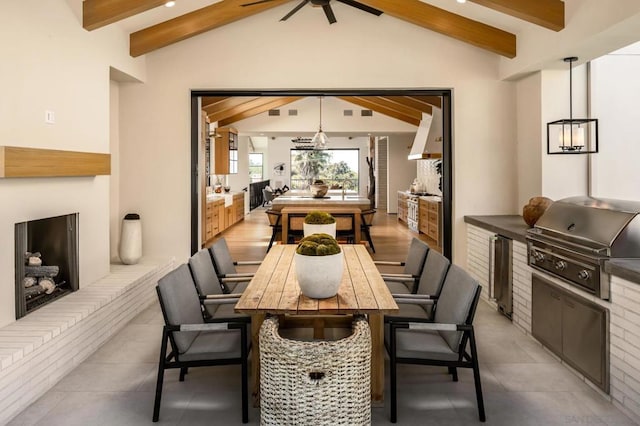 dining area featuring vaulted ceiling with beams, light hardwood / wood-style floors, and ceiling fan