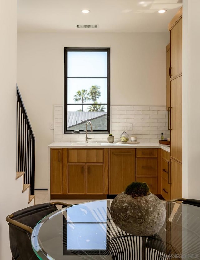 kitchen featuring tasteful backsplash and sink