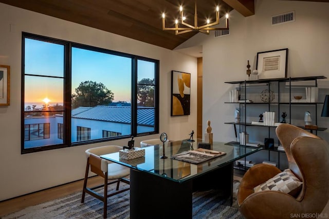 office area with lofted ceiling with beams, hardwood / wood-style floors, and a chandelier