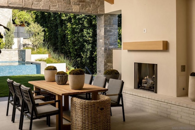 view of patio / terrace featuring an outdoor fireplace