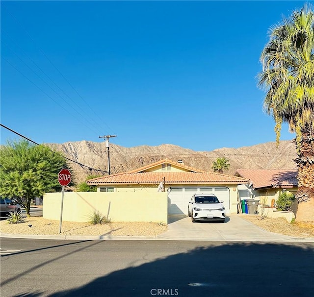 view of front facade featuring a garage and a mountain view