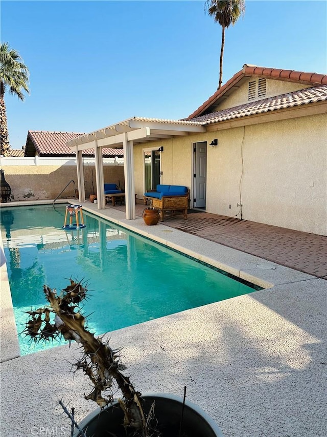 view of swimming pool featuring a pergola and a patio area