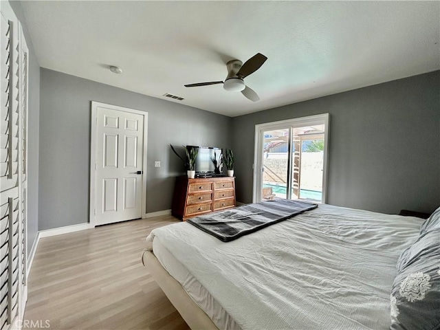 bedroom with ceiling fan, light hardwood / wood-style floors, and a closet