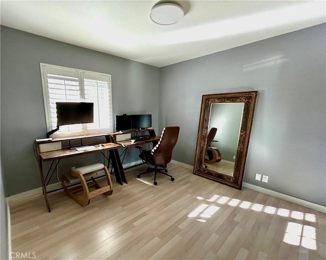 office area with light hardwood / wood-style floors