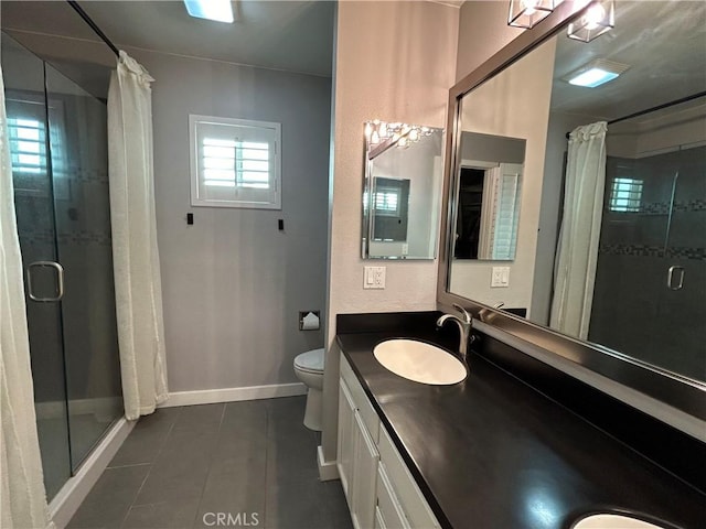 bathroom featuring toilet, tile patterned flooring, vanity, and curtained shower