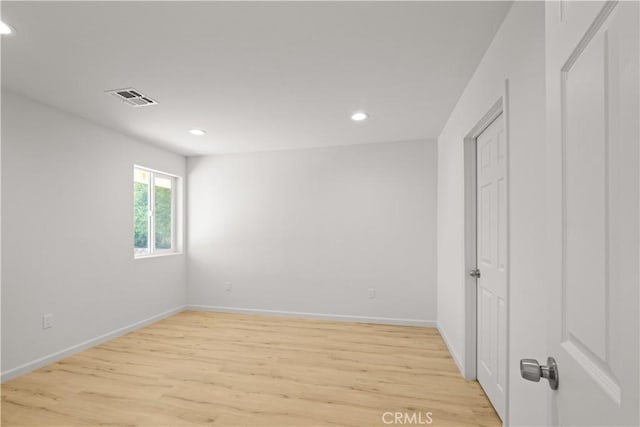 spare room with light hardwood / wood-style flooring