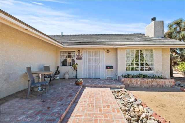 doorway to property with a patio