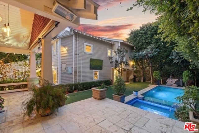 view of swimming pool with a patio area and an in ground hot tub