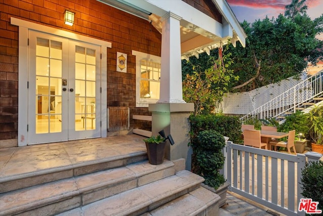 exterior entry at dusk with french doors