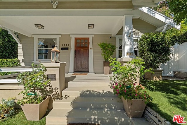 property entrance featuring covered porch