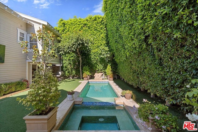 view of pool featuring an in ground hot tub