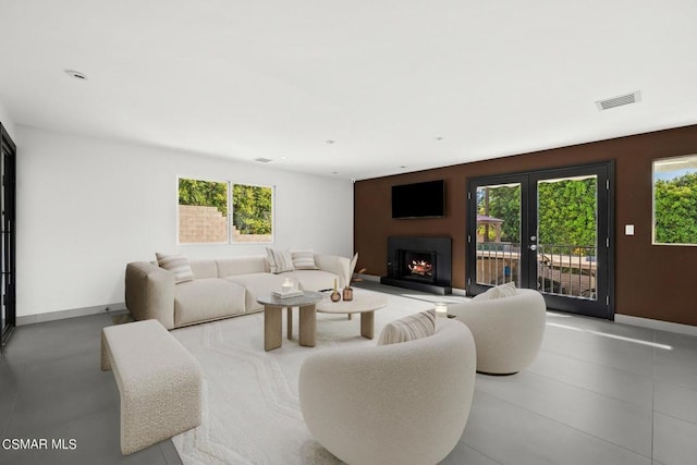 living room featuring plenty of natural light and french doors