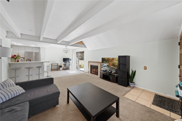 living room featuring a notable chandelier, lofted ceiling with beams, and light colored carpet