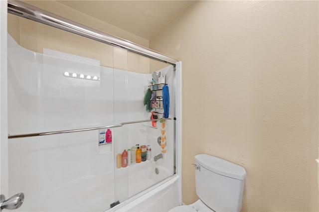 bathroom featuring toilet and enclosed tub / shower combo