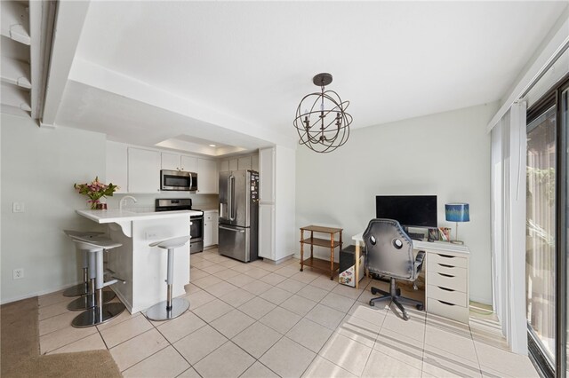 office featuring a chandelier, light tile patterned floors, and sink