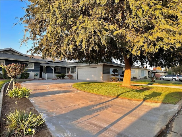 single story home with a garage and a front lawn