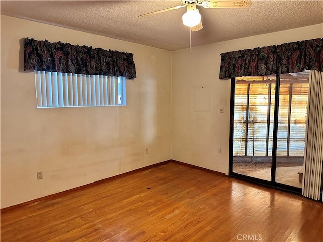 empty room with wood-type flooring, a textured ceiling, and ceiling fan