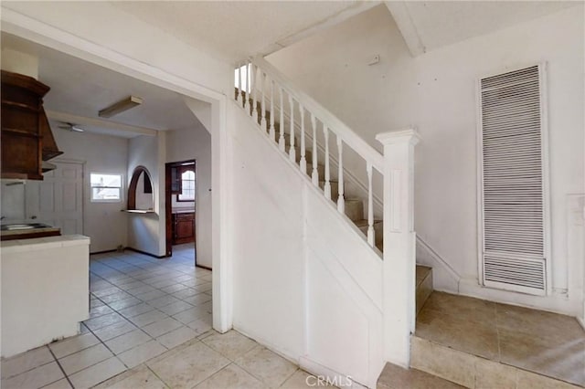 stairs with tile patterned floors