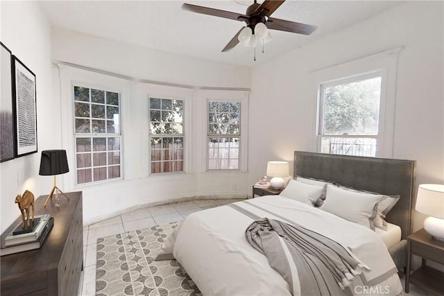 tiled bedroom featuring ceiling fan