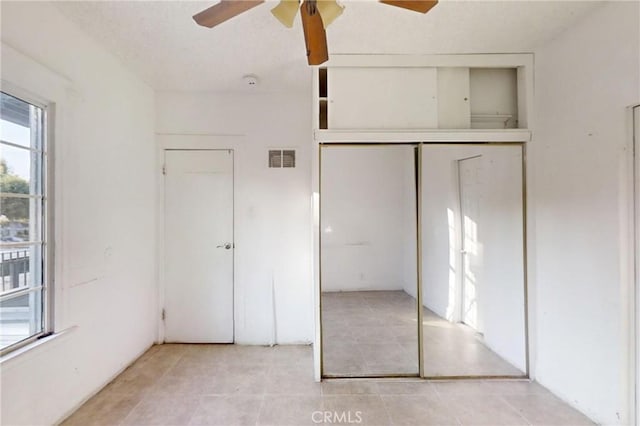 unfurnished bedroom featuring ceiling fan