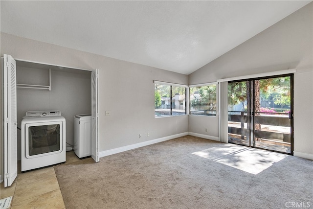 interior space with washing machine and clothes dryer, a healthy amount of sunlight, and light colored carpet