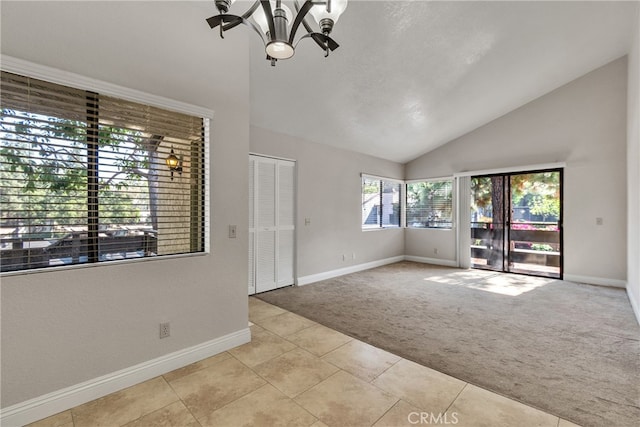 unfurnished living room with vaulted ceiling, a notable chandelier, and light colored carpet