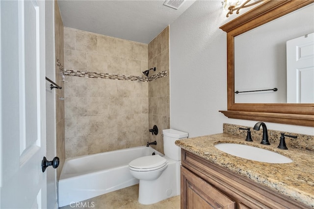 full bathroom with vanity, toilet, tiled shower / bath combo, and a textured ceiling