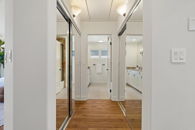 corridor with light hardwood / wood-style flooring