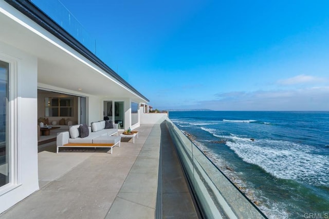 balcony featuring an outdoor living space and a water view