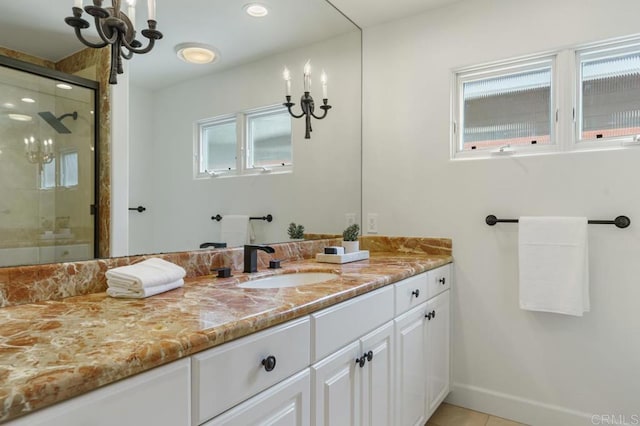 bathroom featuring vanity, an enclosed shower, tile patterned flooring, and plenty of natural light