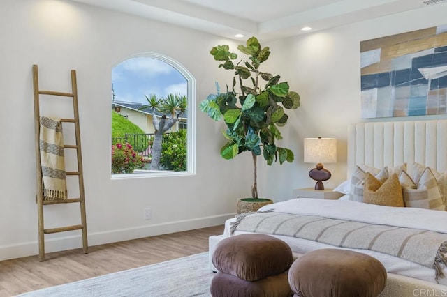 bedroom featuring light hardwood / wood-style floors and multiple windows