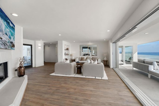 living room featuring hardwood / wood-style floors and a water view