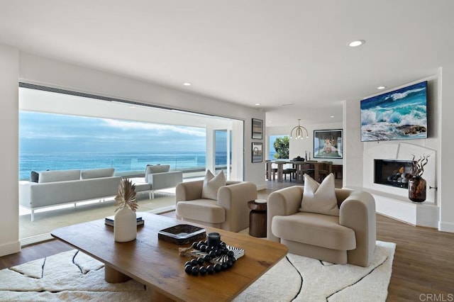 living room featuring wood-type flooring and a water view