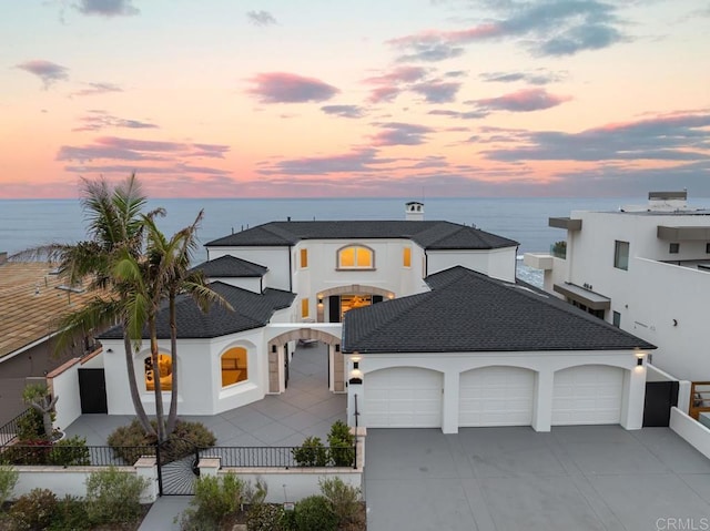 view of front of house featuring a garage and a water view