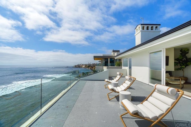 balcony featuring a water view