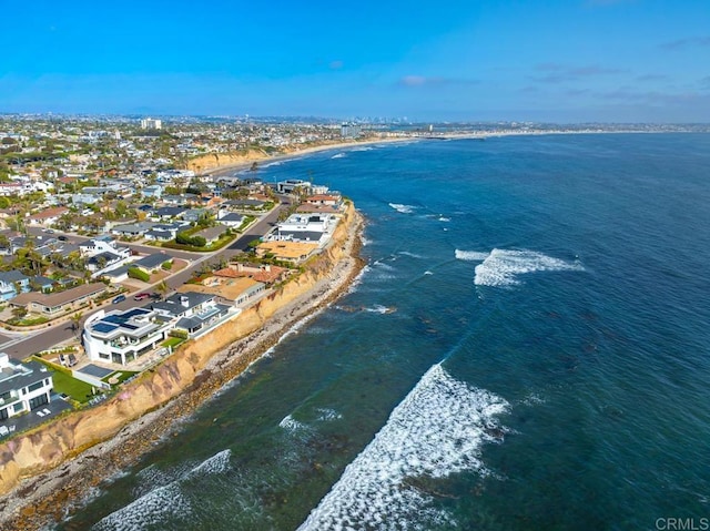 birds eye view of property with a water view and a view of the beach