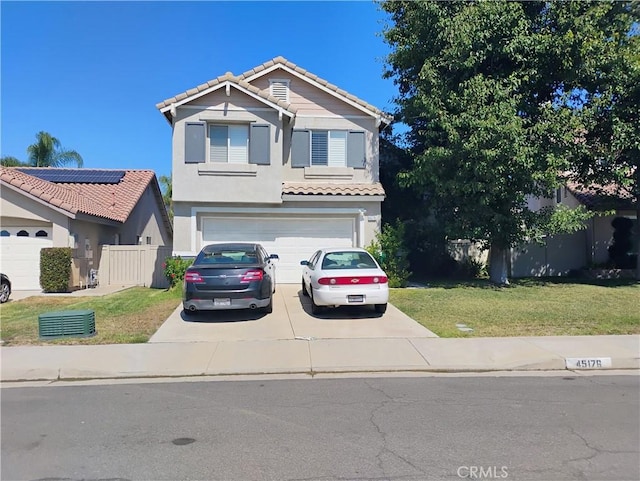 view of front of property featuring a front yard and a garage