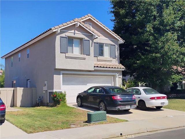 view of front of house featuring a front lawn and a garage