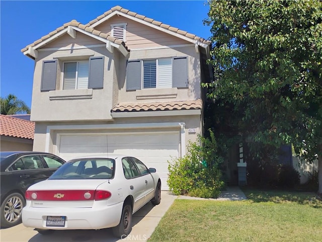 view of front of house with a front yard and a garage