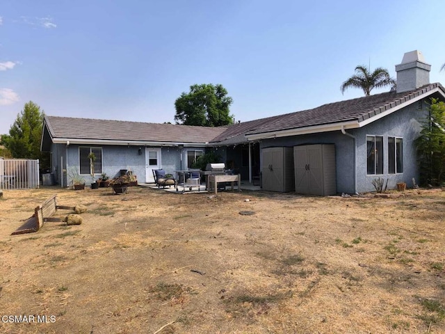 back of property with a patio area