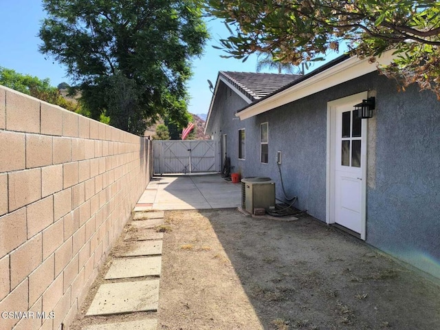 view of side of home with central air condition unit