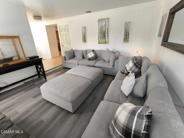 living room with dark hardwood / wood-style floors and ornamental molding