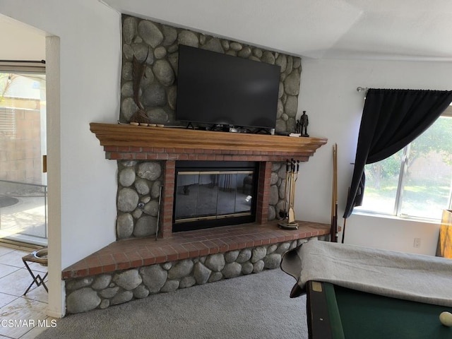 interior details with a fireplace and carpet