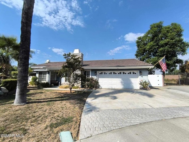 view of front facade with a garage and a front lawn