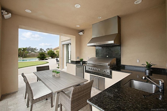 view of patio / terrace featuring an outdoor kitchen, a grill, sink, and a swimming pool