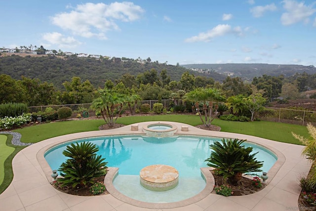 view of swimming pool featuring a yard and an in ground hot tub