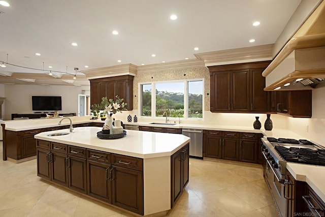 kitchen with appliances with stainless steel finishes, sink, and an island with sink